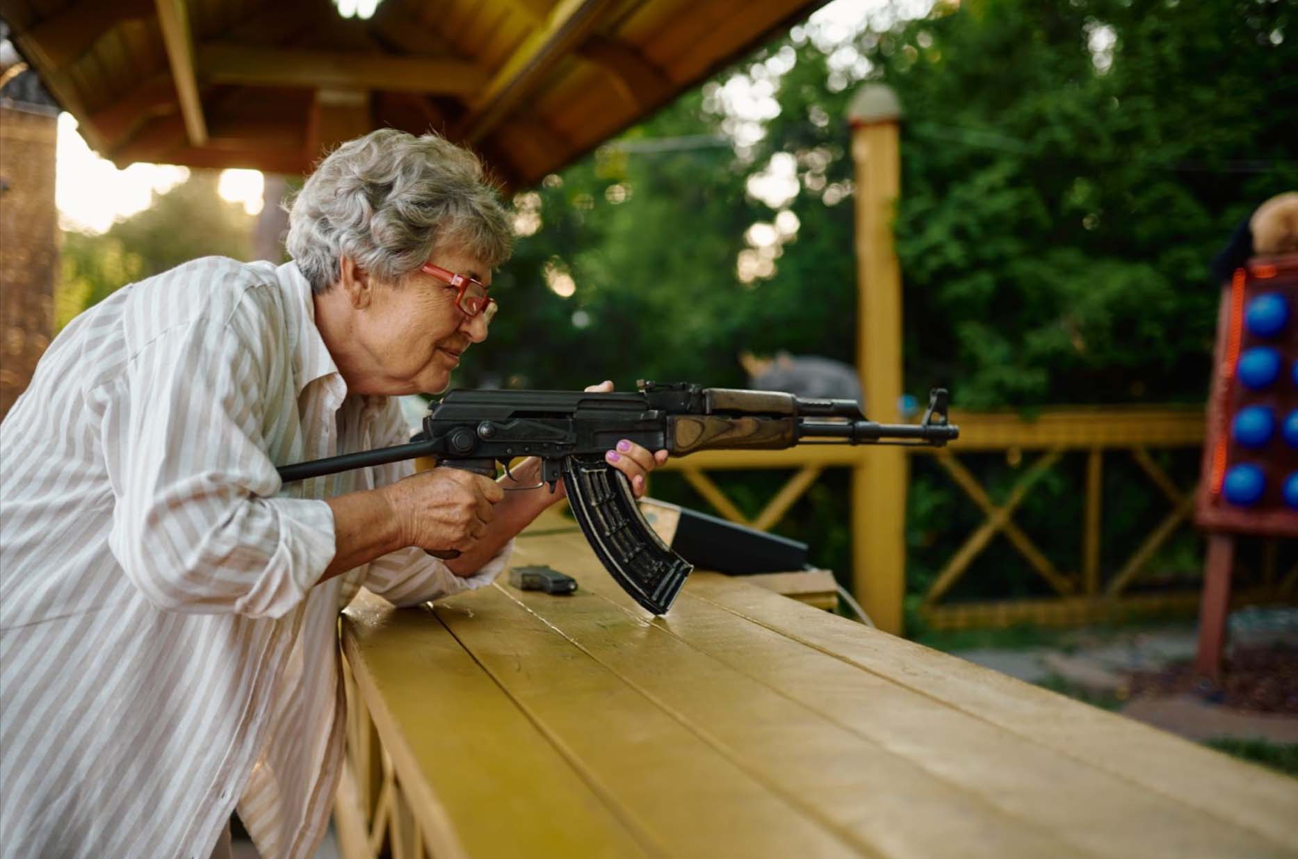 A grandmother participates in a home defense training session at a shooting range, practicing with precision and focus.