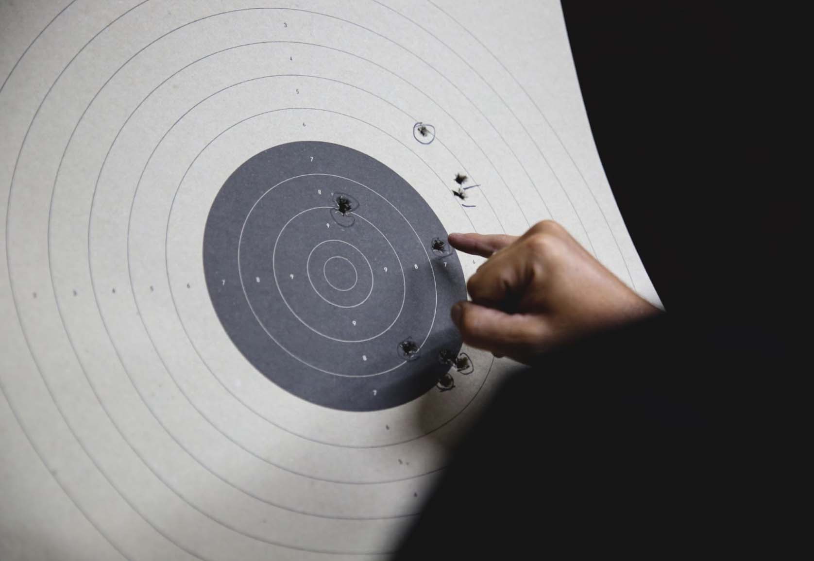 Bullet impressions on paper target following a pistol target shooting.