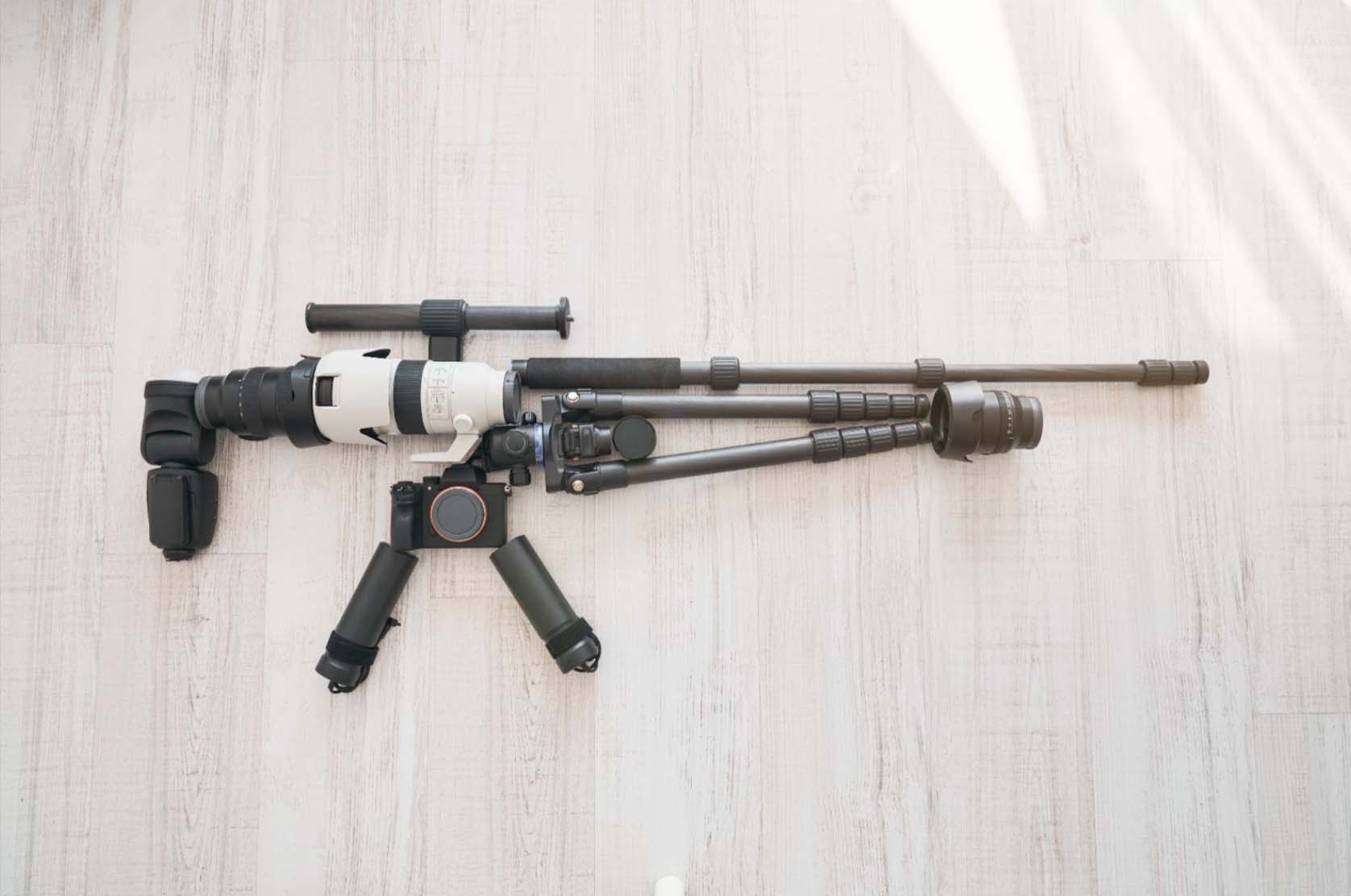 Elegant black and white sniper rifle displayed on a white background.