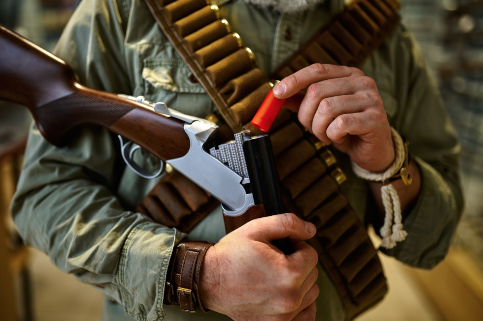 Man with a shoulder belt with pockets for cartridges