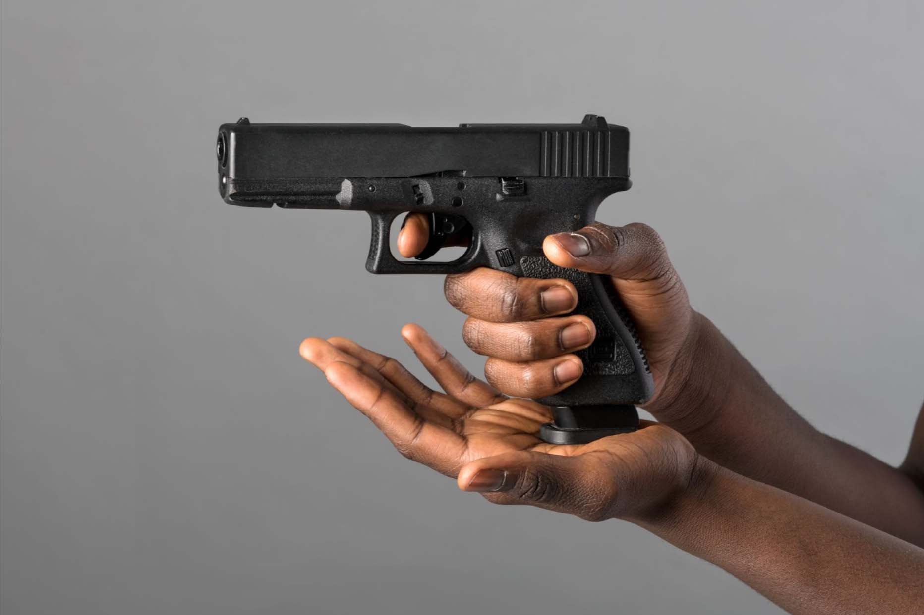 Person holding a gun.