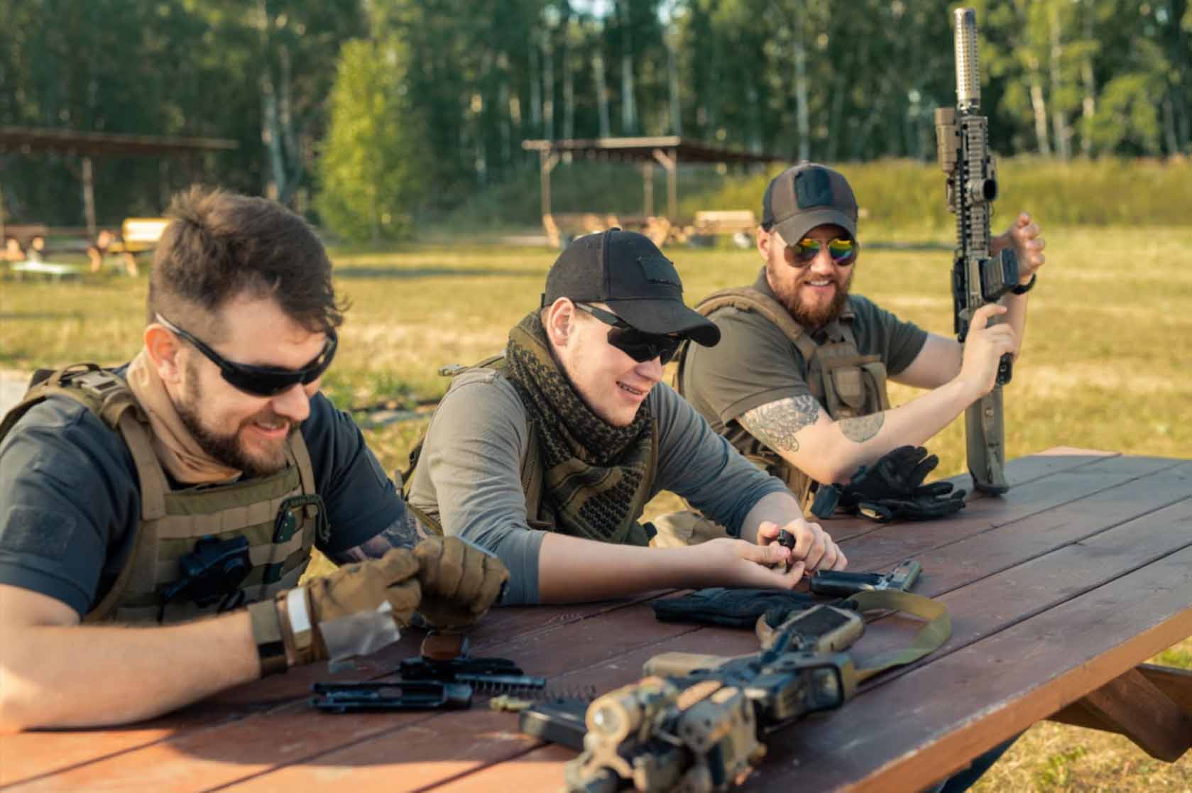 Three men, each attentively reloading their firearms, demonstrating readiness and precision.