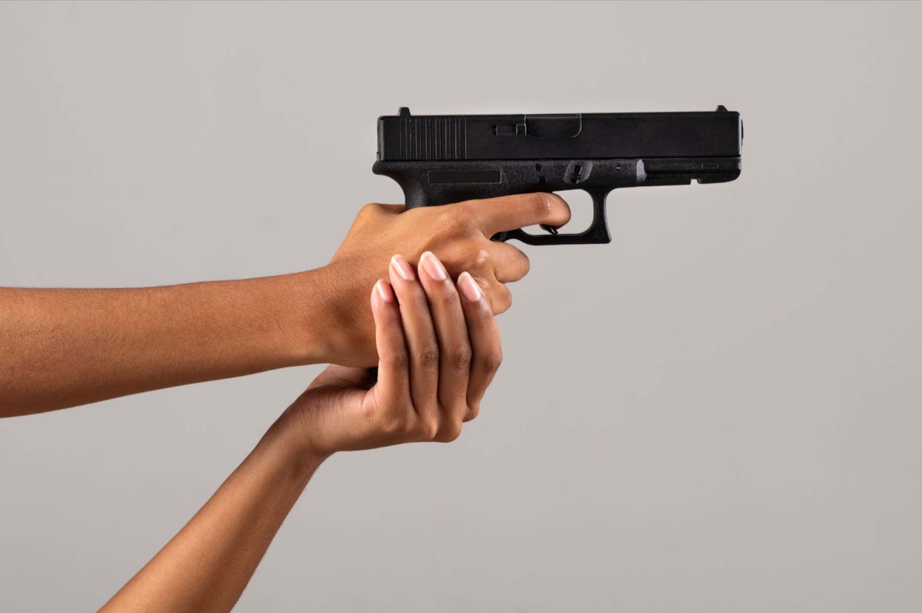 Woman holding a gun.